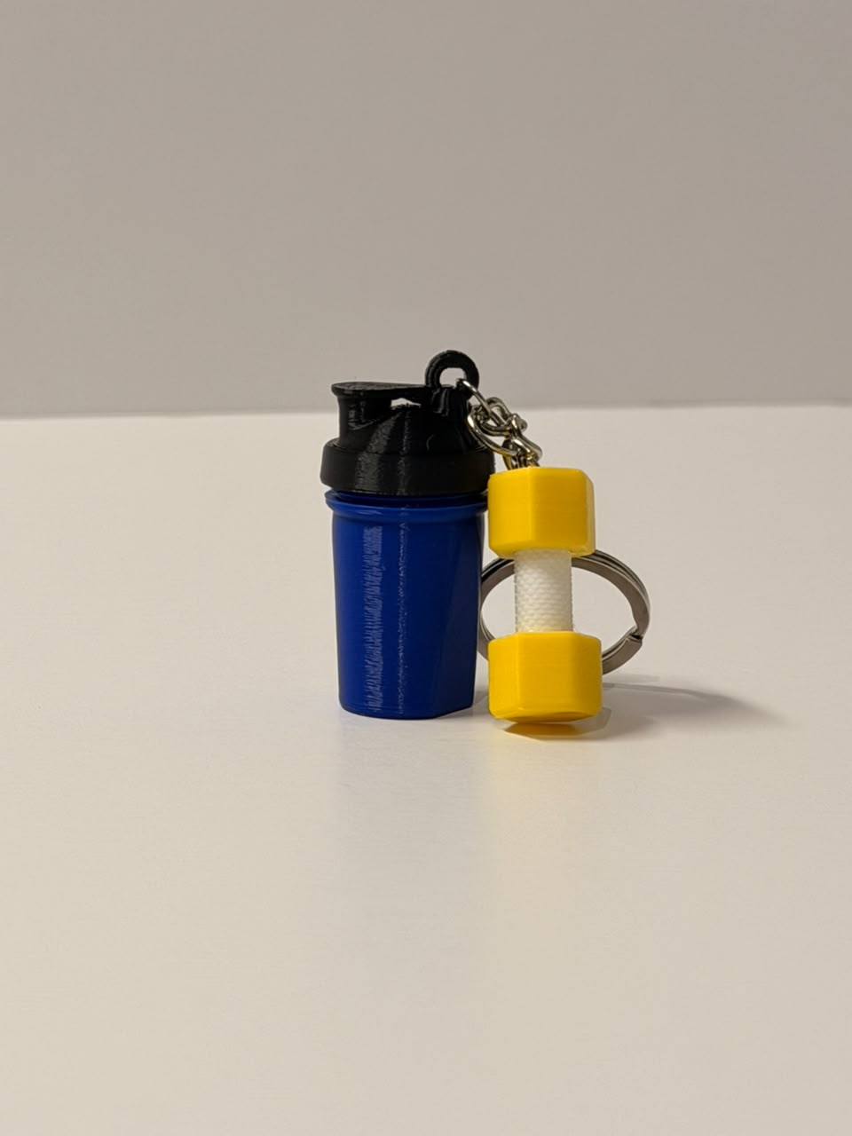 Blue Shaker with a Yellow Dumbell Keychain